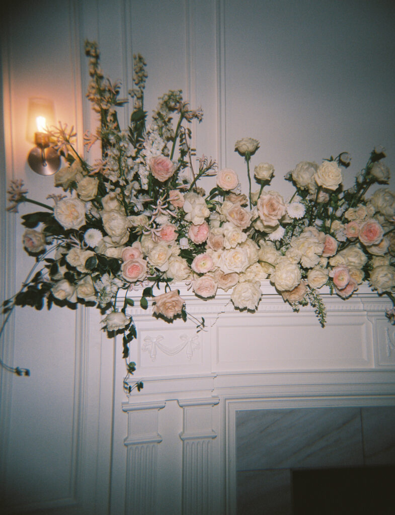 Holga film photo on Portra 400 of a large fireplace mantel flower piece. 