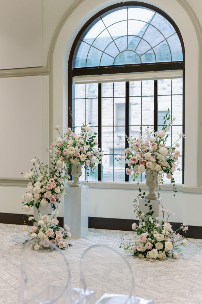 Ceremony site indoors at the FW Phil Center. Large arched windows and grand spring flowers. 

