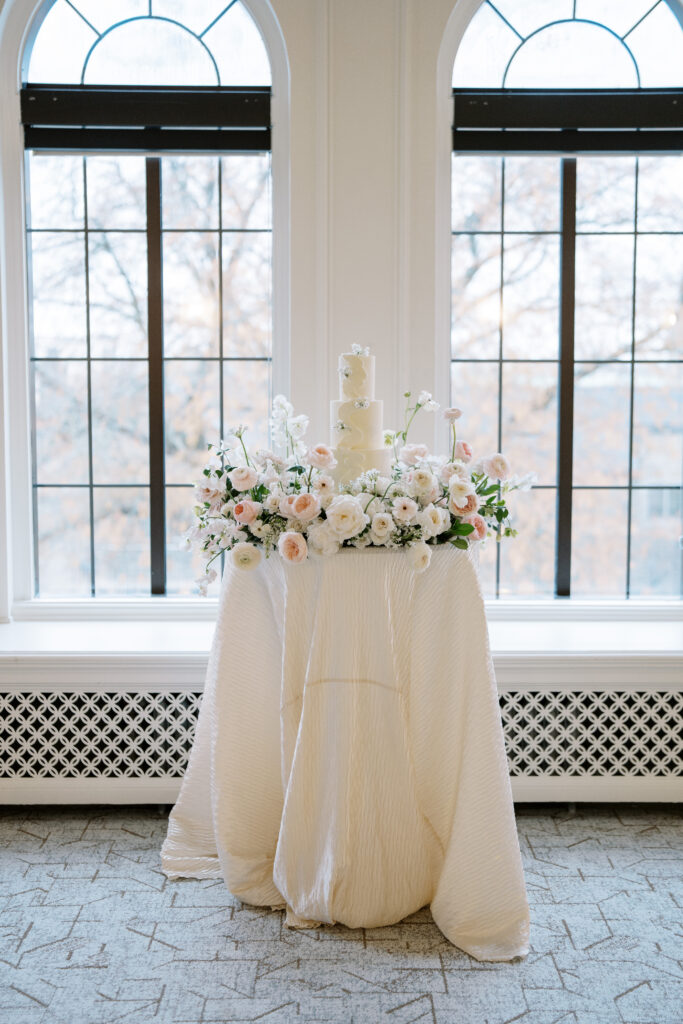 Cake table design inspiration with a flower meadow. Linens from BBJ La Tavola. 