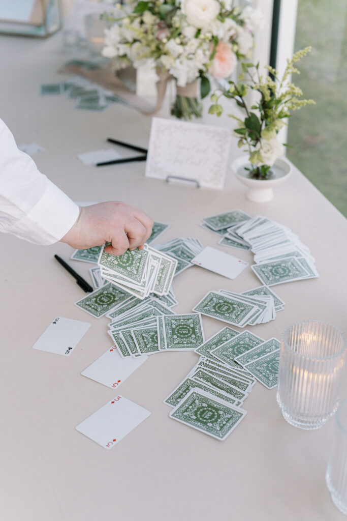 Interactive guest activity with deck of cards during cocktail hour at Ritz Charles Garden pavilion