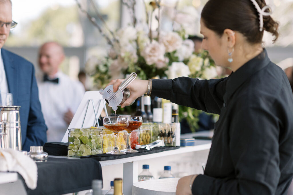 Bartender making specialty cocktails during mingling hour