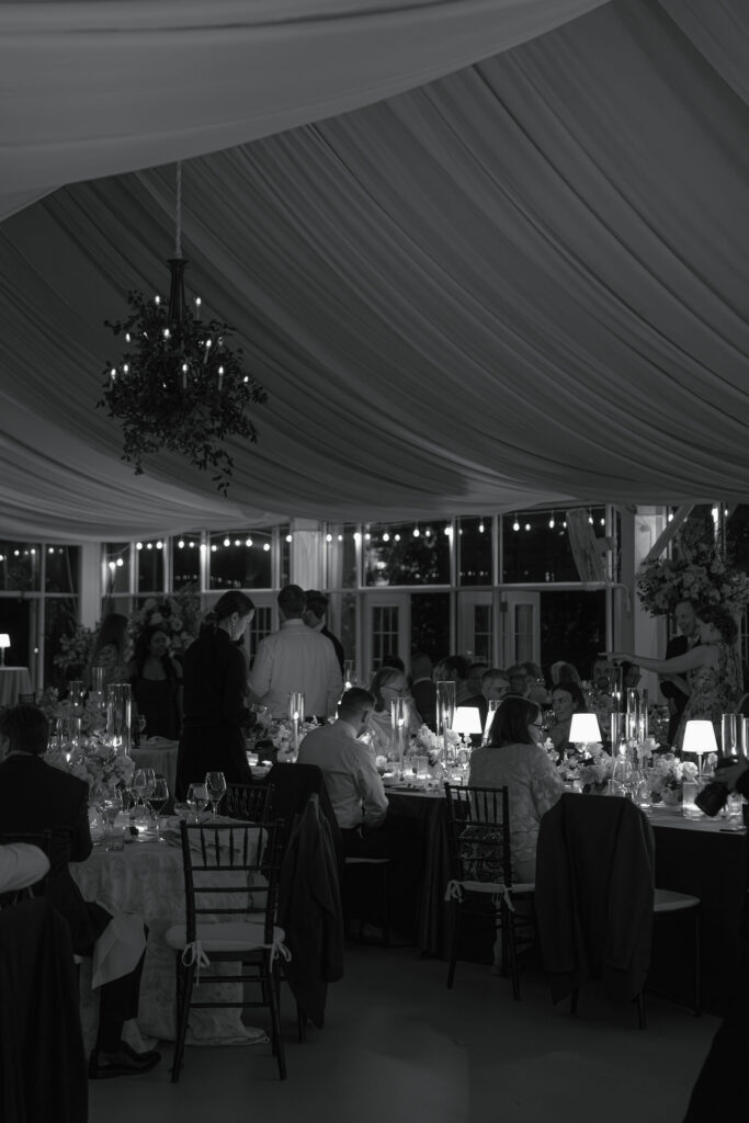 Ambient candid shot in black and white of guests enjoying dinner