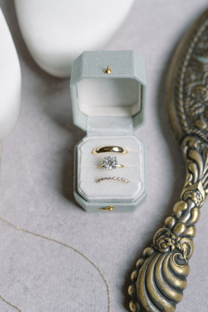 Bride and groom's macro ring shot in heirloom linen box