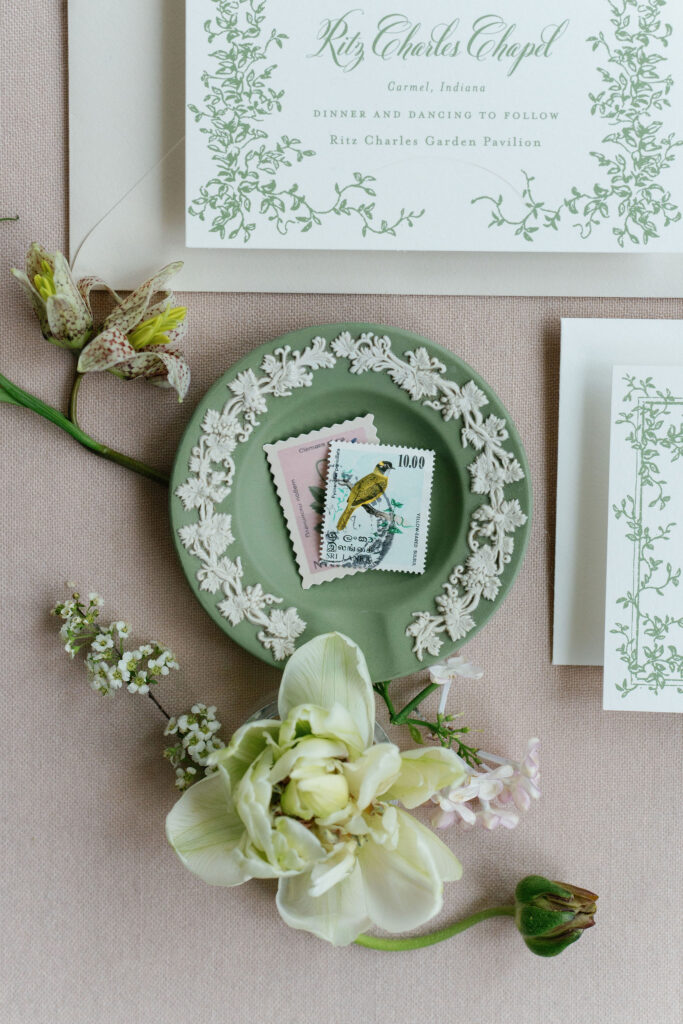 Bird stamps in wedding flatlay detail photos with Wedgwood dish