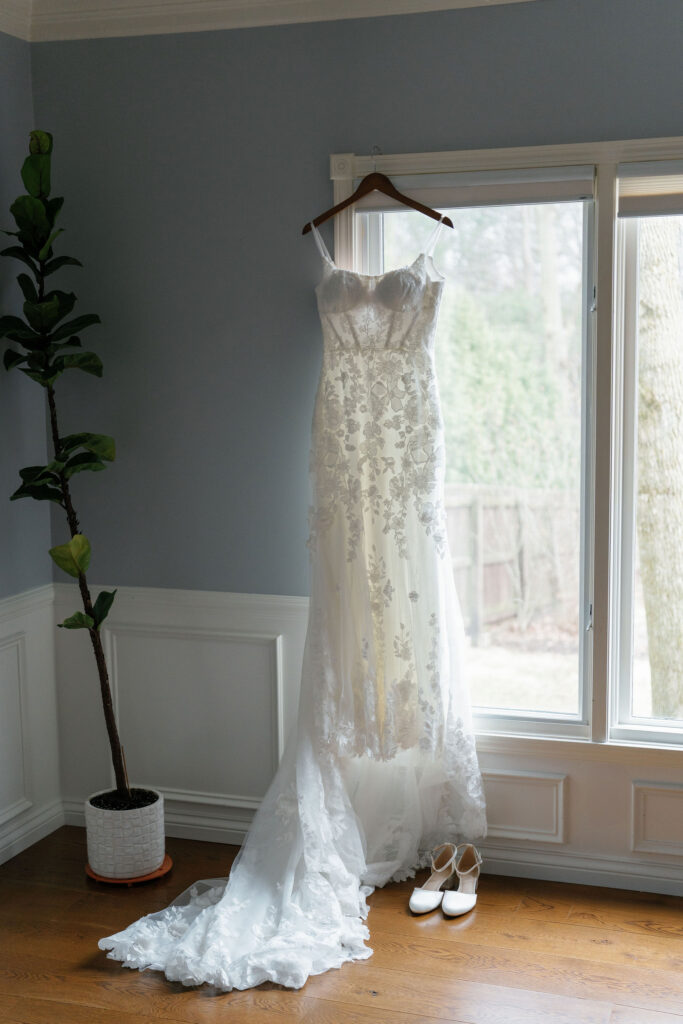Brides dress from The Wedding Studio hanging inside of home.